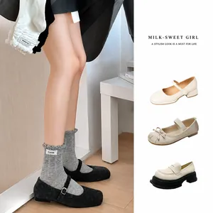 Women's ruffle knit crew socks with Mary Jane shoes and loafers in a cozy home setting
