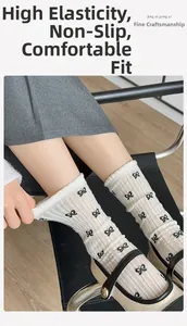 Detail of white mesh socks with black bow patterns and high-elastic ribbed cuffs