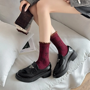 Women's deep red bow jacquard socks paired with black patent leather loafers