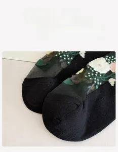 Detailed close-up of seamless toe stitching on black floral mesh socks for women