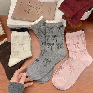 Cozy cotton bow pattern crew socks with ruffle edges in various warm autumn colors