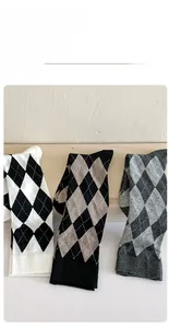 Detail of argyle pattern knit socks in various classic color combinations and soft texture