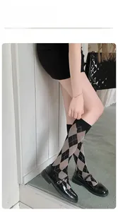 Detail of argyle pattern calf socks with elastic cuffs and black Mary Jane shoes