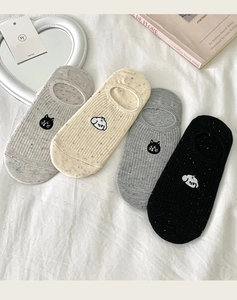 Detail of no-show socks featuring cute cartoon dog embroidery and ribbed knit texture
