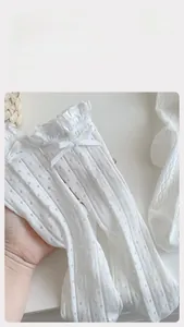 Detailed view of white mesh crew socks with lace ruffles and a sweet bow accent
