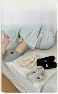 Close-up of low cut invisible socks with cute cat embroidery and ribbed cotton texture