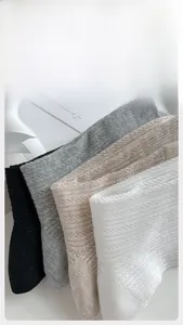 Detail of mesh cotton socks in black, grey, beige, and white colors for summer breathability