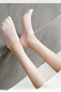 Close-up of pink mesh no-show socks with breathable knit texture and elastic cuff