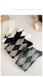 Detailed close-up of knitted argyle patterned knee-high socks in various color combinations