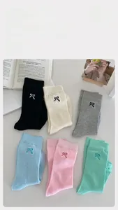 Detailed embroidery of small bows on cotton crew socks in six assorted candy colors