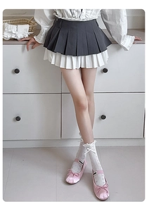 Detail of pink satin bow Mary Jane shoes paired with white lace-edged crew socks