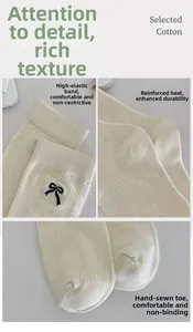 Detail of beige cotton socks with black bow embroidery and reinforced toe stitching