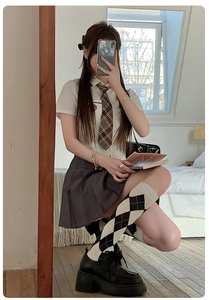 Detail of JK school uniform with white shirt, grey pleated skirt and argyle calf socks