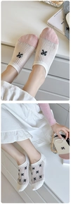 Close-up of Japanese style breathable low cut socks with cute bowknot and striped texture
