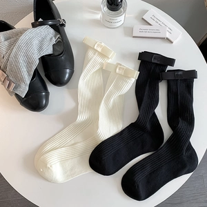 Japanese style white ribbed mid-calf socks with elegant bows and chic black leather shoes