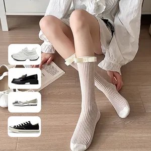 White mid-calf rib-knit socks with delicate bow accents for a sweet Japanese style