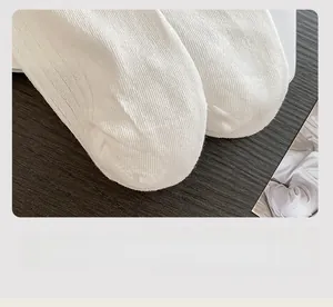 Detail of the flat stitched toe and fine knit texture on these white cotton socks