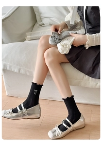 Detail of sweet ruffle cuffs and small bow embroidery on these stylish crew socks