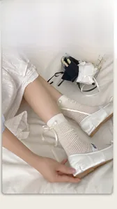 Detail of white cotton crew socks with vertical stripes and a large satin side bow
