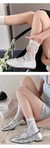 Close-up of white ribbed knit socks with embroidered bow and elegant Mary Jane shoes