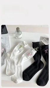 Détails de chaussettes en coton avec broderie nœud délicate et texture côtelée respirante