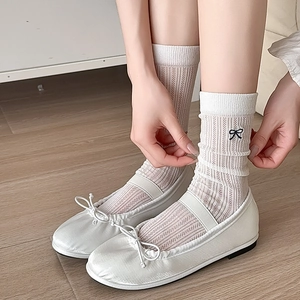 White ribbed mid-calf socks with black bow embroidery paired with satin ballet flats