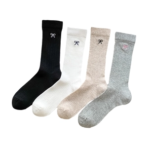 Bowtie embroidered slouch socks in white, black, beige and grey with ribbed texture