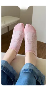 Close-up of pink low-cut sock with smiley pattern and high-elasticity ankle cuff
