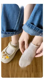 Detail of comfortable cotton low-cut socks with smiley face pattern and loose cuffs