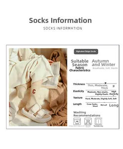 Detail view of beige embroidered wool socks with C letter and product specifications