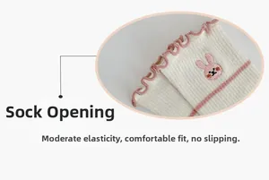 Detail view of white socks with pink ruffle trim and cute rabbit embroidery
