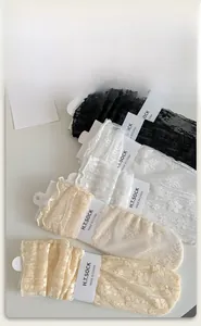 Detail of floral lace mesh socks in various soft colors with paper card packaging