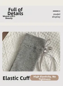 Detail of high-elasticity ribbed sock cuff with grey satin bow decoration