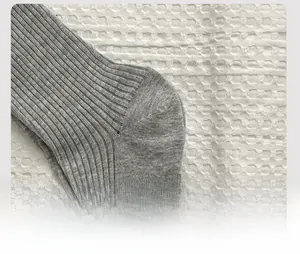 Detail shot of the reinforced heel structure on grey vertical ribbed cotton socks