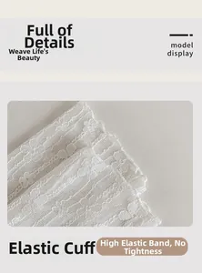 Detail of white lace socks featuring floral mesh patterns and elastic wavy cuffs