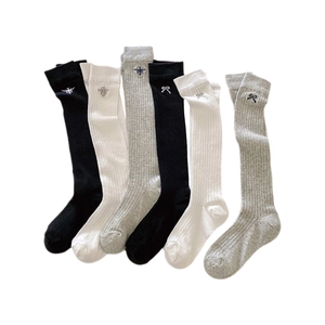Three pairs of ribbed knee-high socks in black white and grey with bee embroidery