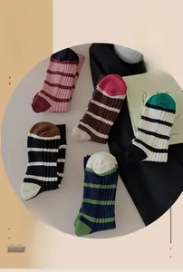 Close-up of five pairs of striped cotton crew socks in assorted vintage color patterns