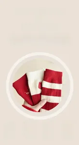 Close-up of thick red wool socks and striped pattern with soft warm cashmere texture
