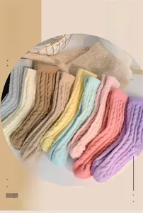 Close-up of cable knit coral fleece socks in assorted warm macaron colors for winter