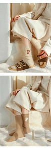 Detail of wool socks with P letter embroidery and plush slippers on soft rug