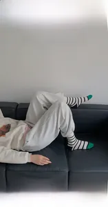 Close-up of retro striped mid-calf socks with green toe detail on feet
