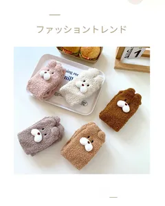 Close-up of fluffy coral fleece socks with cute 3D bear dolls in five warm colors