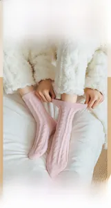 Detail showing elastic soft pink coral fleece socks with vertical stripe knit pattern