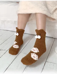Detail of coral fleece thick socks with 3D teddy bear ears and pink paw print patterns