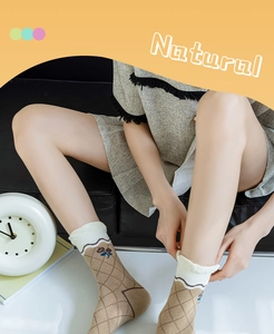 Detail of khaki cotton mid-calf socks with floral patterns and white ruffle cuffs