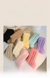 Texture detail of soft thermal plush socks in ten different pastel candy colors