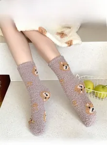 Detail of warm grey-purple coral fleece crew socks with cartoon bear pattern on model