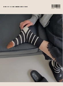 Detail of vintage striped knit socks featuring black and white patterns and brown toe accents