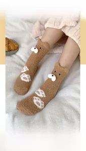 Detail of plush brown teddy fleece socks featuring 3D bear design and paw prints