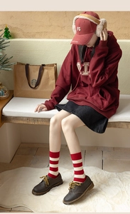 Detail shot of red and white striped winter cashmere socks paired with retro brown shoes